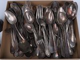 many spoons and forks in a box on the table