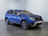 the blue dacia is parked in a white room with a black floor