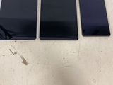 trois téléphones portables posés les uns à côté des autres sur une table