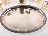 a silver tray with silver cups and a silver tray with silver cups