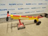 a small red and yellow hand truck with a yellow handle