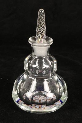 a close up of a clear glass bottle with a glass top
