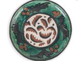 a picture of a green and brown plate with a design on it