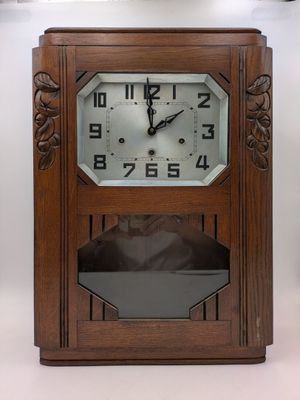 a clock that is sitting on a shelf in a room