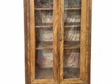an old wooden bookcase with glass doors and shelves