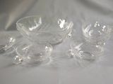 a group of glass bowls and cups sitting on a table