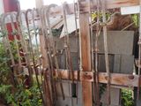 a wooden fence that has a bunch of sticks on top of it