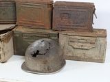 a pile of old boxes and a helmet sitting on a table