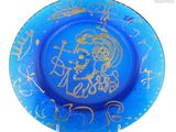 a blue plate with a drawing of a woman on it