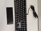 a keyboard and a remote on a white surface