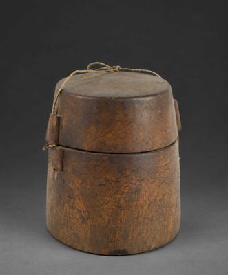 an old wooden box with a rope around it