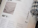 a picture of a bed with a sheet of paper on top of it