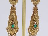 an image of a pair of gold earrings with emerald stones