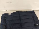 a close up of a black quilted jacket on a white surface