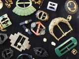 many different types of belts and buckles laid out on a table