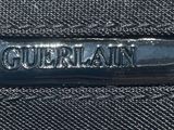 the back of a black purse with the word gubbaan on it