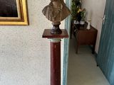 a bust of a man on a pedestal in a room