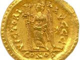 a gold coin with an image of a woman holding a child