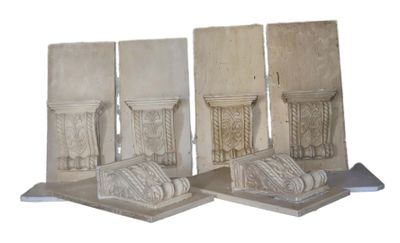 four pieces of carved stone are sitting on a white surface