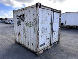 a white container with graffiti on it in a parking lot