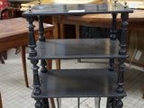 a black shelf with three shelves on top of it