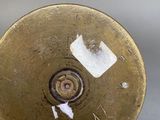 a small brass object with a hole in the middle