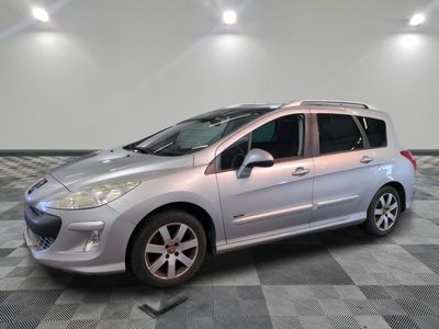 the small silver car is parked in a room with a checkered floor