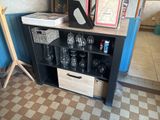 a shelf with wine glasses on it in a room