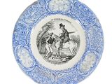 an old blue and white plate with a drawing of a man on a horse