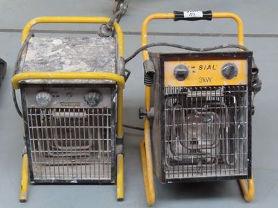 two portable heaters sitting next to each other on the floor