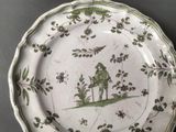 a green and white plate with a picture of a man on it