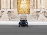 a blue car that is parked in front of a building