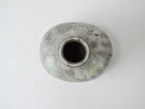 a white vase with a hole in it on a table