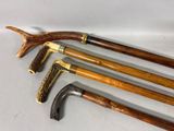 several different types of canes are lined up on a white surface