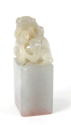 a picture of a piece of white jade with a carved animal on top of it