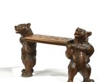 two bears that are standing next to a bench