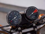 two gauges on the handlebars of a motorcycle