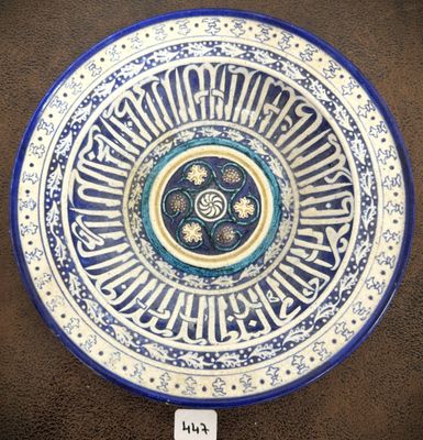 assiette en céramique bleue et blanche ornée d'une calligraphie arabe