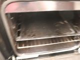 an open oven with a lot of food inside of it
