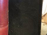 two speakers sitting next to each other on the floor