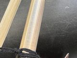 two chopsticks that are tied together on a table