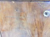 a piece of wood that has been scratched off and is sitting on top of a table