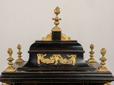a black and gold clock sitting on top of a table