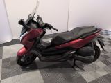 a picture of a red motorcycle parked on a checkered floor
