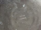 a large metal bowl with writing on it