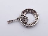 silver plated pendant with a skull in the center
