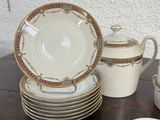a lot of plates and cups on a wooden table
