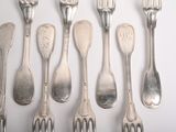 a lot of silver spoons and forks on the table