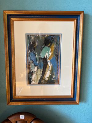 a picture of a clock on a table next to a painting