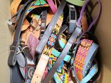 a cardboard box filled with lots of different types of belts